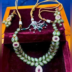 Rich uncut diamond look alike gold tone necklace with earrings .